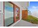 Contemporary front entrance with a stylish wooden accent wall and an address marker at 11050 7Th E St, Treasure Island, FL 33706