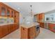 Spacious kitchen with stainless steel appliances and custom cabinetry with view to the living room at 11050 7Th E St, Treasure Island, FL 33706