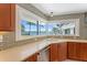 Bright kitchen area with sleek countertops, views of the water, and stainless dishwasher at 11050 7Th E St, Treasure Island, FL 33706
