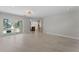 View from open-concept living space of modern kitchen and floor-to-ceiling sliding doors to backyard pool at 11050 7Th E St, Treasure Island, FL 33706