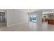 Open-concept living space with floor-to-ceiling sliding doors to the backyard pool and views of the ocean at 11050 7Th E St, Treasure Island, FL 33706