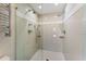 Modern shower with dual shower heads and tiled walls at 11050 7Th E St, Treasure Island, FL 33706