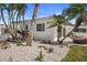 This home offers lush tropical landscaping and a new white pebble perimeter at 11050 7Th E St, Treasure Island, FL 33706