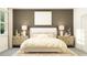 Bright bedroom featuring a stylish bed, matching nightstands and lamps, and a neutral color palette at 11821 Sparkling Topaz Cv, Parrish, FL 34219