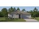 Charming single-story home featuring a gray exterior, well-manicured lawn, and attached two-car garage at 12969 Shining Blue Nile Ln, Parrish, FL 34219