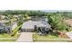 A charming home with a tile roof is situated on a lush, green lot near a tranquil lake, offering beautiful curb appeal at 1307 Forestedge Blvd, Oldsmar, FL 34677