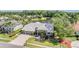 Aerial view of house with a three car garage and lovely landscaping at 1307 Forestedge Blvd, Oldsmar, FL 34677