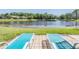 Gorgeous backyard with a view of the water and lounge chairs at 1307 Forestedge Blvd, Oldsmar, FL 34677