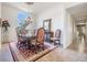 The dining room includes an elegant chandelier, a large window, and a view into the front foyer at 1307 Forestedge Blvd, Oldsmar, FL 34677