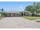 Beautiful house with a large driveway, manicured lawn and landscaping at 1307 Forestedge Blvd, Oldsmar, FL 34677