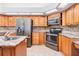 Kitchen with stainless appliances, granite countertops, and wood cabinets at 1307 Forestedge Blvd, Oldsmar, FL 34677