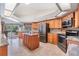 Eat-in kitchen features stainless appliances, granite countertops, island and lots of storage at 1307 Forestedge Blvd, Oldsmar, FL 34677