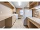 Large laundry room with ample counter space, washer, dryer, and refrigerator at 1307 Forestedge Blvd, Oldsmar, FL 34677