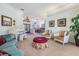 Elegant living room is shown from an angle displaying multiple chairs, sofa, white piano, and access to the formal dining room at 1307 Forestedge Blvd, Oldsmar, FL 34677