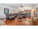 Open-concept living area featuring hardwood floors and an adjacent dining space at 1307 Forestedge Blvd, Oldsmar, FL 34677