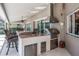 Outdoor kitchen with granite countertops, stainless steel appliances, a built-in grill, and a ceiling fan at 1307 Forestedge Blvd, Oldsmar, FL 34677