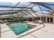 Enclosed pool area with ample space for lounging and a built-in hot tub at 1307 Forestedge Blvd, Oldsmar, FL 34677