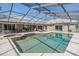 Inviting pool area with covered seating and an outdoor bar, perfect for entertaining guests at 1307 Forestedge Blvd, Oldsmar, FL 34677