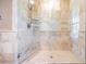 Modern shower with elegant tile work, a built-in shelf, and glass door at 1307 Forestedge Blvd, Oldsmar, FL 34677