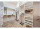 Spacious walk-in closet with custom shelving, drawers, and hanging rods for optimal organization at 1307 Forestedge Blvd, Oldsmar, FL 34677
