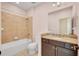 Well-lit bathroom featuring a shower-tub combo, granite vanity, and tile flooring at 13611 Circa Crossing Dr, Lithia, FL 33547