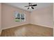 Bedroom features wood floor, ceiling fan and a large window at 13611 Circa Crossing Dr, Lithia, FL 33547