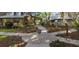 Beautifully landscaped entrance to the community with paved walkways and mature trees at 13611 Circa Crossing Dr, Lithia, FL 33547