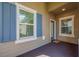 Inviting front porch with blue shutters, a blue door and textured carpeting at 13611 Circa Crossing Dr, Lithia, FL 33547