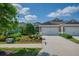 Charming townhome with a two-car garage, lush landscaping, and a welcoming entryway at 13611 Circa Crossing Dr, Lithia, FL 33547