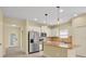 Open kitchen with stainless steel appliances, granite countertops, and a tile backsplash at 13611 Circa Crossing Dr, Lithia, FL 33547