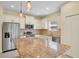 Bright kitchen features stainless appliances, granite countertops, and pendant lighting at 13611 Circa Crossing Dr, Lithia, FL 33547