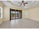 Spacious living room features tile floors, ceiling fan, and sliding glass doors to the lanai at 13611 Circa Crossing Dr, Lithia, FL 33547