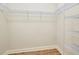 Walk-in closet features metal shelving and wood floors at 13611 Circa Crossing Dr, Lithia, FL 33547