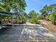 Charming backyard featuring a gazebo, lush greenery and wooden path, enhancing the outdoor living experience at 1417 W Curlew Pl, Tarpon Springs, FL 34689