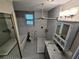 Clean bathroom with tub, shower and modern fixtures, featuring black and white tile at 1417 W Curlew Pl, Tarpon Springs, FL 34689