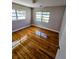 Sunlit bedroom with hardwood flooring and windows offering scenic views at 1417 W Curlew Pl, Tarpon Springs, FL 34689