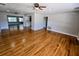Open-concept floor plan with hardwood floors connecting to the kitchen at 1417 W Curlew Pl, Tarpon Springs, FL 34689