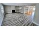 Spacious living room with fireplace, wood-look flooring and lots of natural light at 1417 W Curlew Pl, Tarpon Springs, FL 34689