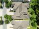 Aerial view of townhome roofs, green lawns, and driveways with surrounding trees at 14616 Rocky Brook Dr, Tampa, FL 33625