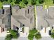 Overhead shot of townhomes featuring neatly arranged rooflines, driveways, and verdant lawns at 14616 Rocky Brook Dr, Tampa, FL 33625