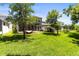 Lush green backyard featuring a screened lanai, perfect for outdoor living and entertaining at 14616 Rocky Brook Dr, Tampa, FL 33625