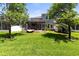 Lush green backyard featuring a screened lanai, perfect for outdoor living and entertaining at 14616 Rocky Brook Dr, Tampa, FL 33625
