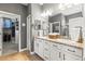 Bathroom featuring double sinks with granite countertops and a walk-in closet at 14616 Rocky Brook Dr, Tampa, FL 33625