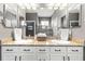 Bathroom showcasing dual sinks with granite countertops and modern fixtures at 14616 Rocky Brook Dr, Tampa, FL 33625