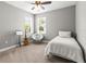 Bright bedroom with neutral walls, two windows, and a cozy chair, perfect for a reading nook at 14616 Rocky Brook Dr, Tampa, FL 33625