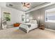 Bright bedroom with a cozy bed, a tray ceiling and large windows for natural light at 14616 Rocky Brook Dr, Tampa, FL 33625