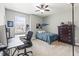 Comfortable bedroom with neutral walls, carpet flooring, ceiling fan, and a workspace at 14616 Rocky Brook Dr, Tampa, FL 33625