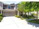 Two-story home featuring a well-manicured lawn, mature tree and an attached two-car garage at 14616 Rocky Brook Dr, Tampa, FL 33625