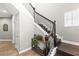 Bright foyer with decorative console table by dark wood stairs, and neutral paint color at 14616 Rocky Brook Dr, Tampa, FL 33625