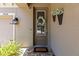 Beautiful front door with decorative wreath and flowers, number placard, and craftsman lighting at 14616 Rocky Brook Dr, Tampa, FL 33625
